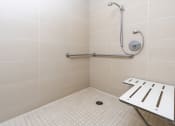 Thumbnail 66 of 75 - a bathroom with a shower and a stool in it