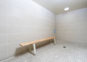 Thumbnail 65 of 75 - a empty room with a wooden bench in the corner