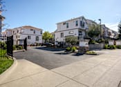 Thumbnail 18 of 46 - A street view of a residential area with houses on both sides.