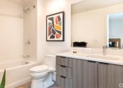 Thumbnail 11 of 30 - a bathroom with a sink and a toilet and a bath tub