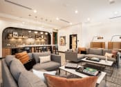 Thumbnail 13 of 30 - a living room with couches and chairs and a bar