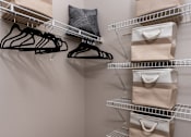 Thumbnail 54 of 98 - a walk in closet with bags and shelves