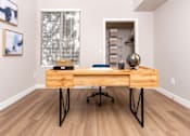 Thumbnail 46 of 98 - a home office with a wooden desk and a large window