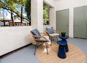 Thumbnail 60 of 98 - a patio with two chairs and a table and a door