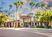 Thumbnail 1 of 98 - 89147 Apartments for Rent Spring Valley NV - Alicante - Leasing Office Exterior Surrounded by Palm Tree and Landscaped Ground, Available Parking in Front