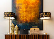 Thumbnail 30 of 98 - a living room with a desk with two lamps and a painting