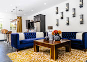 Thumbnail 33 of 98 - a living room with blue couches and a table