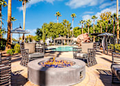 Thumbnail 11 of 98 - an outdoor patio with a fire pit and chairs and a pool