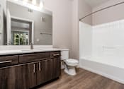 Thumbnail 85 of 98 - Apartments in Spring Valley for Rent - Alicante - Bathroom with Bath Tub, Shower, Wood-Style Flooring, and Large Mirror
