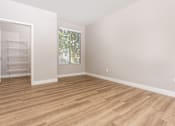 Thumbnail 92 of 98 - an empty room with wood flooring and a closet