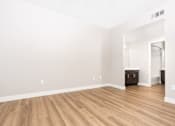 Thumbnail 94 of 98 - an empty living room with white walls and wood flooring