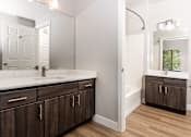 Thumbnail 95 of 98 - a bathroom with wooden cabinets and a sink and a mirror