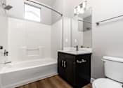 Thumbnail 97 of 98 - a bathroom with a toilet and a sink and a bath tub