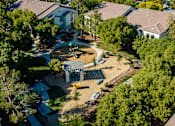 Thumbnail 4 of 98 - an aerial view of a playground in a neighborhood with houses