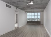 Thumbnail 22 of 29 - Bedroom with large windows at Aqua Via Apartments, California, 94607