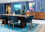 Thumbnail 7 of 29 - furnished lobby with long table and lounge seating at Aqua Via Apartments, California, 94607