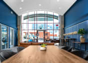 Thumbnail 3 of 29 - entryway lobby with long table and lounge seating at Aqua Via Apartments, California, 94607