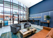 Thumbnail 5 of 29 - furnished lobby with lounge seating at Aqua Via Apartments, Oakland, California