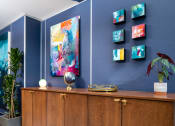 Thumbnail 9 of 29 - furnished lobby with globe and artwork at Aqua Via Apartments, Oakland