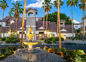 Thumbnail 56 of 57 - A beautifully lit residential area with a fountain in the foreground.