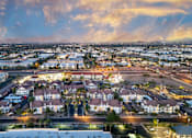 Thumbnail 55 of 57 - A cityscape at dusk with buildings and streets illuminated.