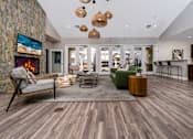 Thumbnail 30 of 57 - A modern living room with a stone wall and a fireplace.