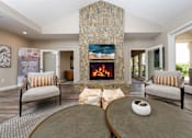 Thumbnail 34 of 57 - A living room with a fireplace and two chairs.