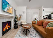 Thumbnail 7 of 57 - A living room with a fireplace and a couch.