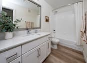 Thumbnail 28 of 57 - A bathroom with a toilet, sink, and bathtub.