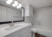 Thumbnail 8 of 29 - A white bathroom with a sink, toilet, and bathtub.