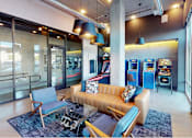 Thumbnail 9 of 18 - A modern living room with a pool table and a sofa.