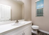 Thumbnail 28 of 60 - a bathroom with a toilet sink and mirror