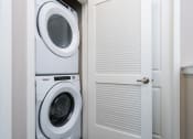 Thumbnail 29 of 60 - a small laundry room with a stackable washer and dryer