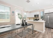 Thumbnail 33 of 60 - a kitchen with a large island and stainless steel appliances