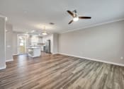 Thumbnail 33 of 83 - A spacious room with a ceiling fan and wooden flooring.