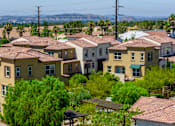 Thumbnail 79 of 83 - A row of houses with green trees in front.