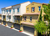 Thumbnail 82 of 83 - A row of houses with garages and driveways.