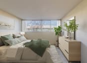 Thumbnail 21 of 86 - 1-Bedroom Apartments in Redwood City, CA - Avenue Two - Bedroom with Carpet Flooring, Full-Size Bed, Nightstand with Lamp, Dresser, Houseplants, and Large Window at Avenue Two Apartments, Redwood City