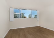 Thumbnail 55 of 86 - jefferson floor plan unfurnished bedroom with wood style plank flooring at Avenue Two Apartments, Redwood City  ,California, 94063
