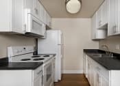 Thumbnail 56 of 86 - jefferson floor plan kitchen with white cabinets at Avenue Two Apartments, California