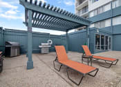 Thumbnail 3 of 86 - avenue two lounge chairs and grill area at Avenue Two Apartments, Redwood City  , CA 94063