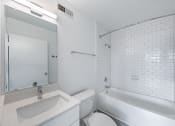 Thumbnail 85 of 86 - a bathroom with a sink toilet and a tub at Avenue Two Apartments, California, 94063
