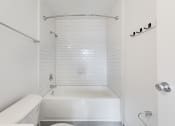 Thumbnail 83 of 86 - a white bathroom with a tub and a toilet at Avenue Two Apartments, Redwood City  ,California, 94063