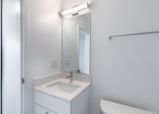 Thumbnail 79 of 86 - an empty bathroom with a sink and a mirror at Avenue Two Apartments, Redwood City  , CA 94063