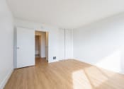 Thumbnail 76 of 86 - a living room with white walls and a wooden floor at Avenue Two Apartments, Redwood City  ,California, 94063