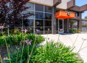Thumbnail 5 of 50 - the front of a building with a sidewalk and plants