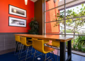 Thumbnail 18 of 50 - a dining room with yellow chairs and a wooden table