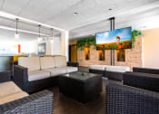 Thumbnail 19 of 50 - a lobby of a hotel with couches and a television
