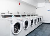 Thumbnail 25 of 50 - a row of washing machines in a laundry room