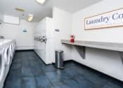 Thumbnail 26 of 50 - a laundry room with a washing machine and a counter